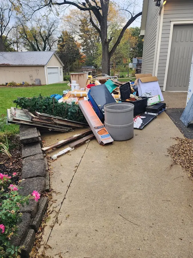 Dumpster being loaded with debris for 10 Yard Dumpster Rental in West Livingston